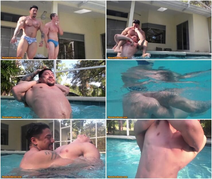 Hot guys fighting in pool with bubbles coming out from their airways - male wrestling